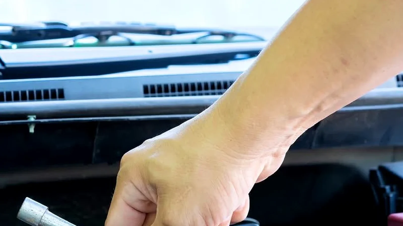 Technician checking starting and charging components under the hood
