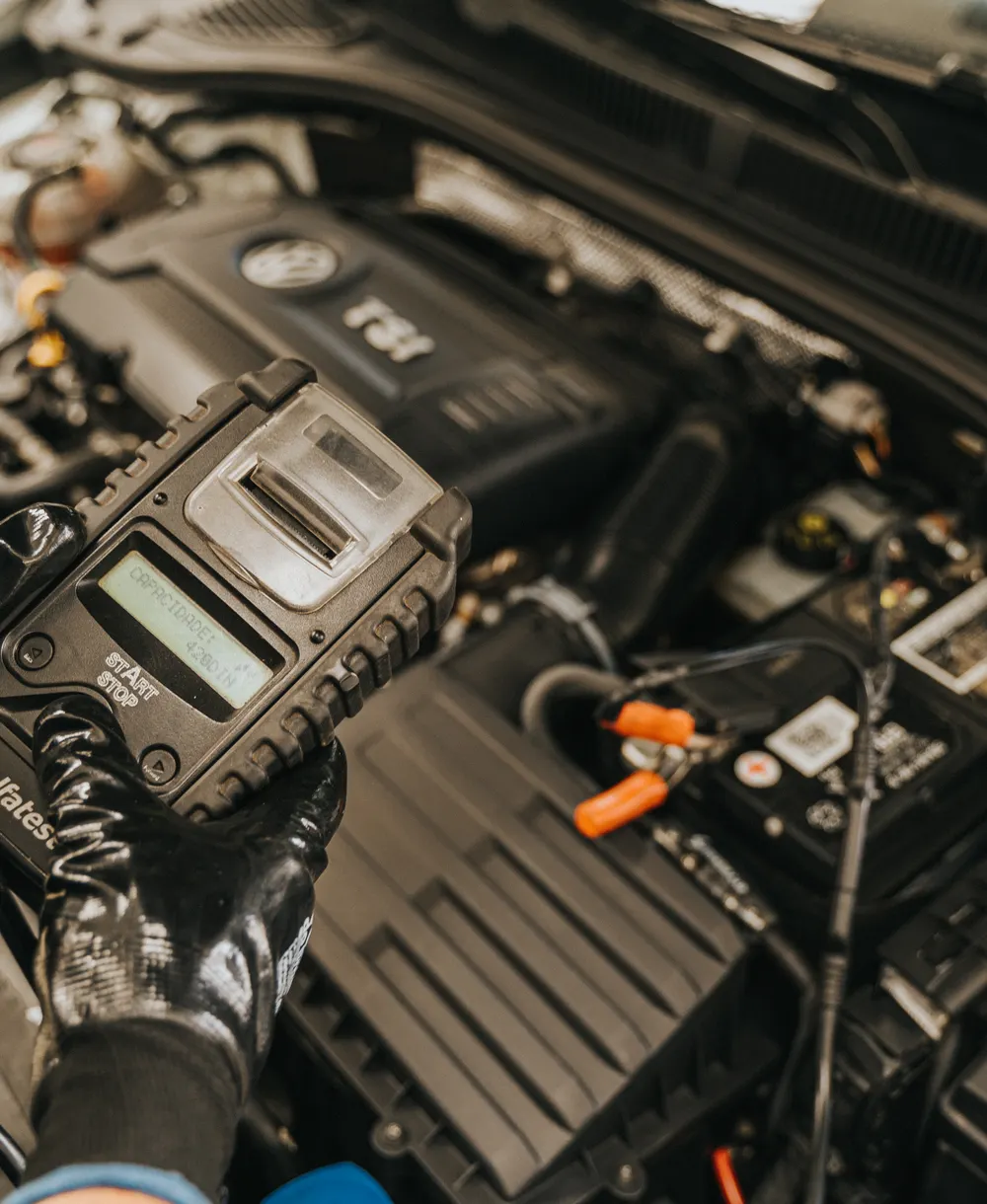Mechanic checking an engine with an automotive diagnostic tool