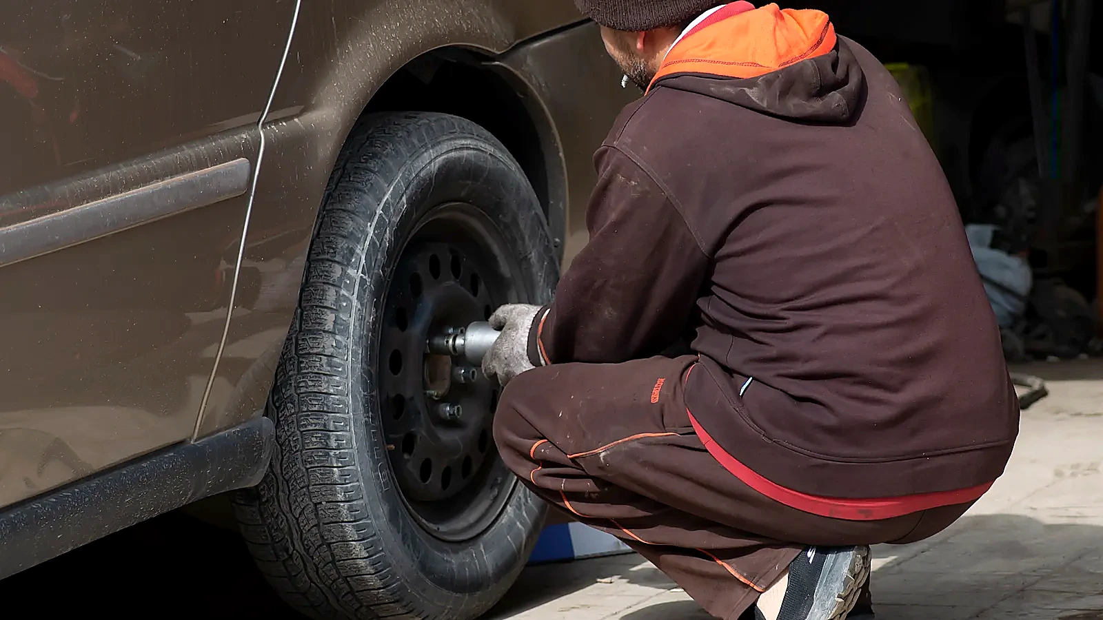 Technician servicing a vehicle tire and wheel